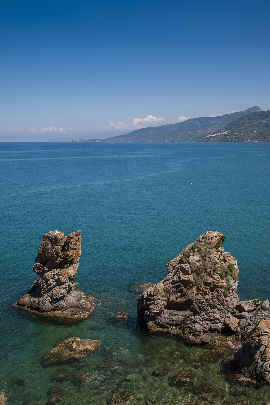 Rocky coast of Sicily beside the blue sea