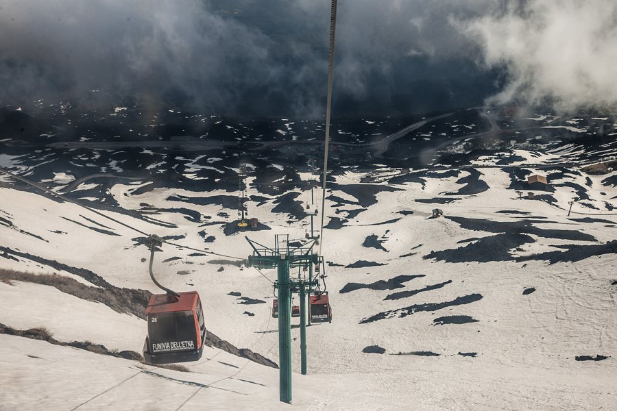 Cable car on Mount Etna above snow-dusted volcanic slopes